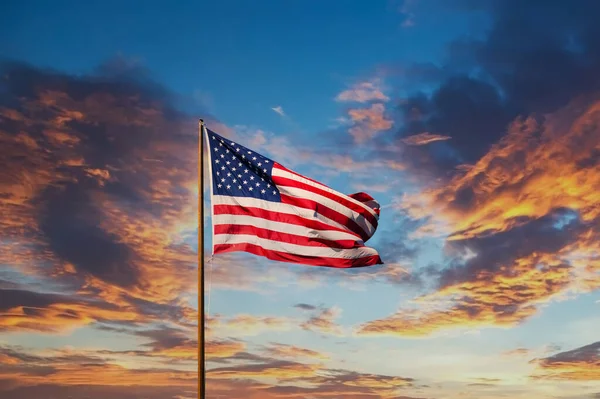 Start a Business in the USA – Stock american flag on old flagpole at sunset