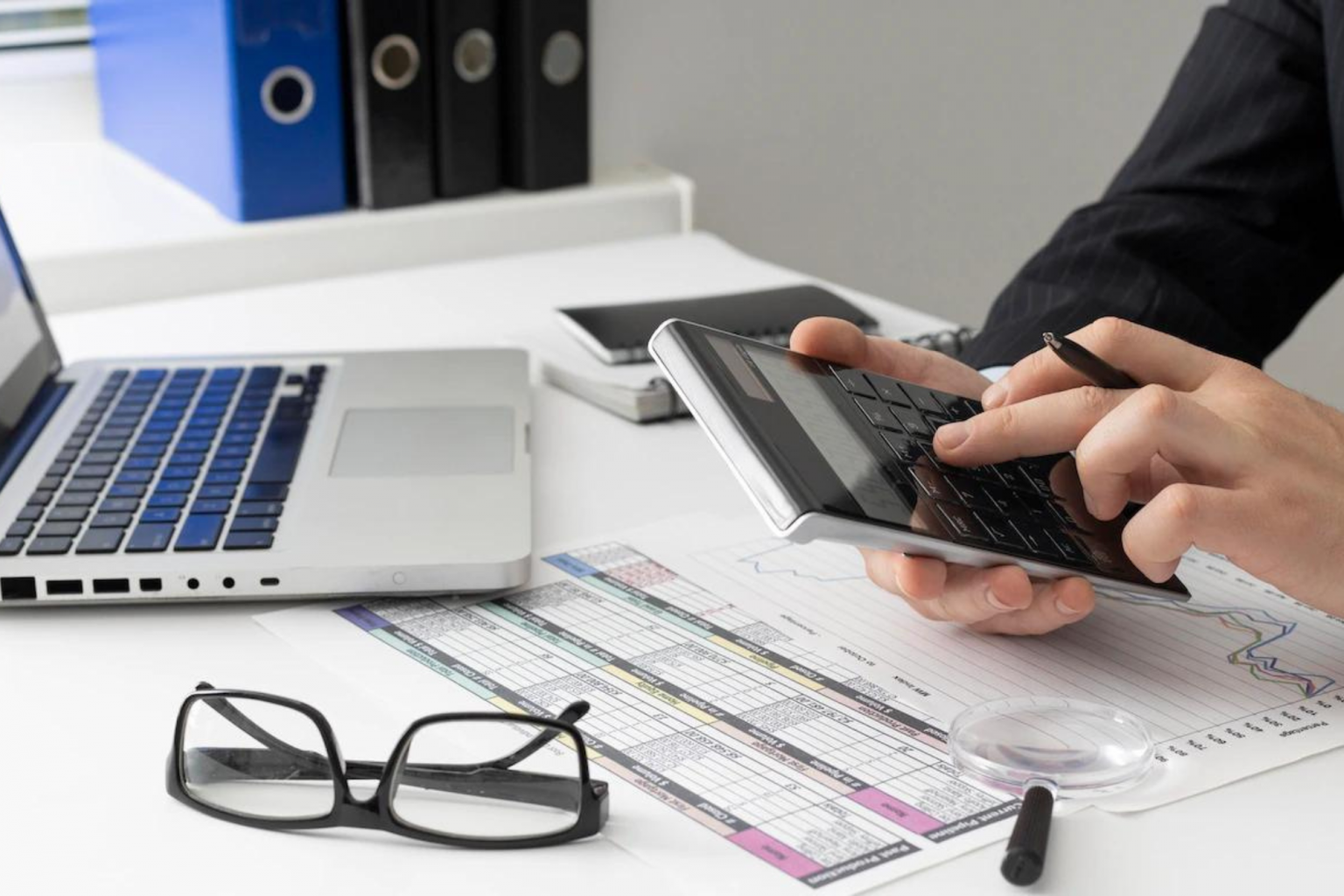 Accountant checking financial documents with a calculator