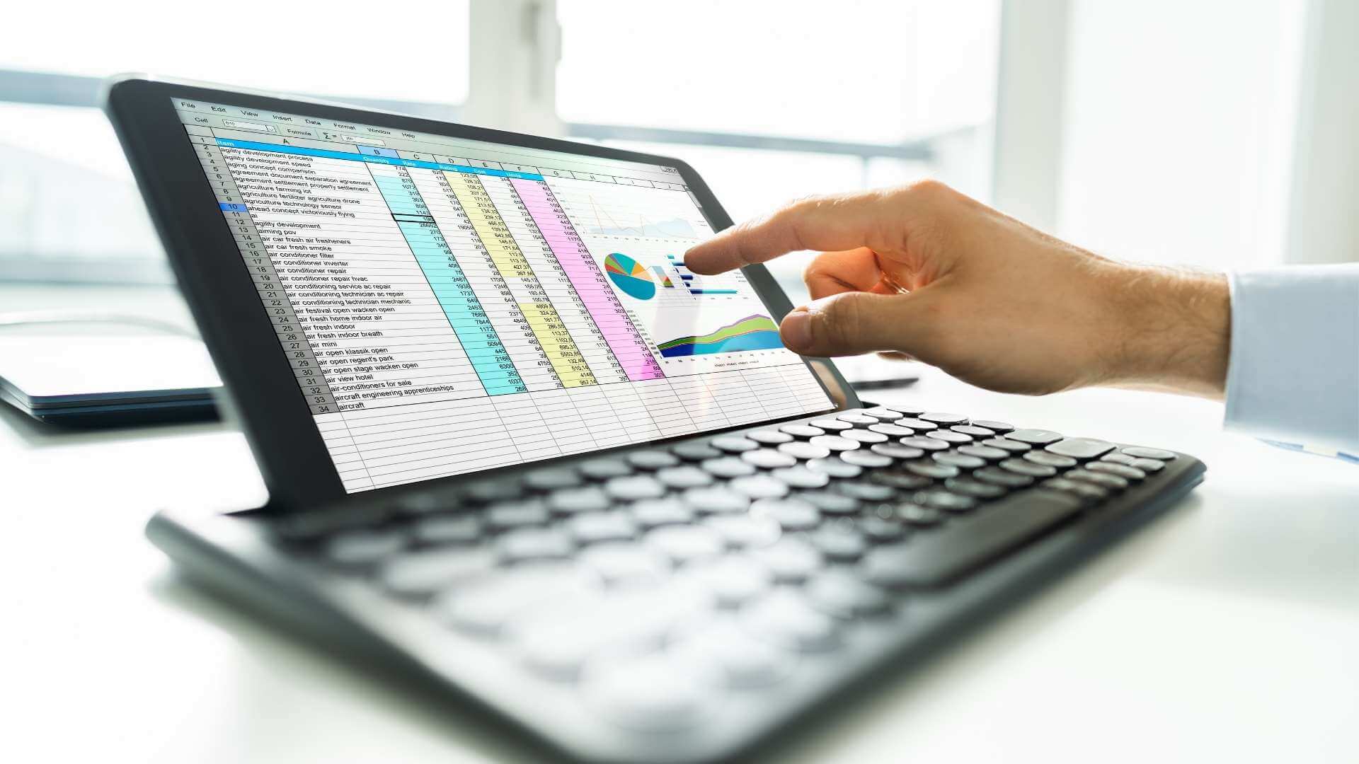 Analyst reviewing a spreadsheet report on a tablet