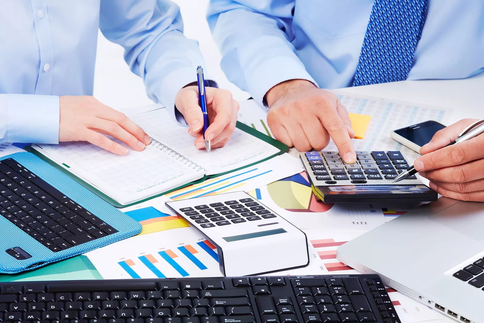 Accounting team reviewing documents with a calculator