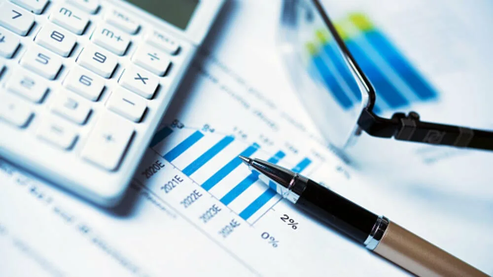 Calculator and financial reports used for Korean company budgeting