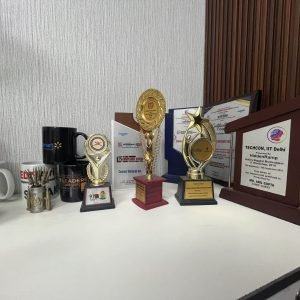 Trophies and framed awards on a shelf