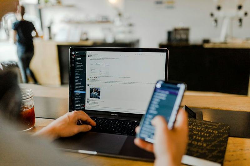 A consultant working on a laptop and phone