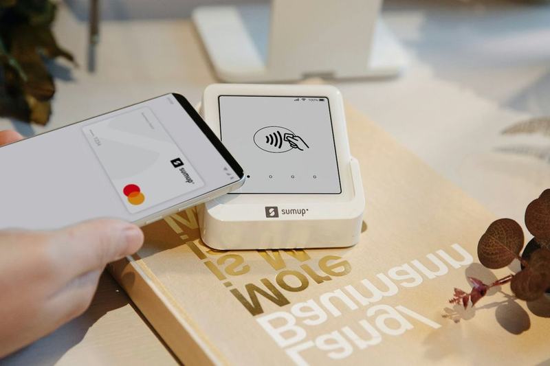 A phone tapped on a card reader to make a contactless payment